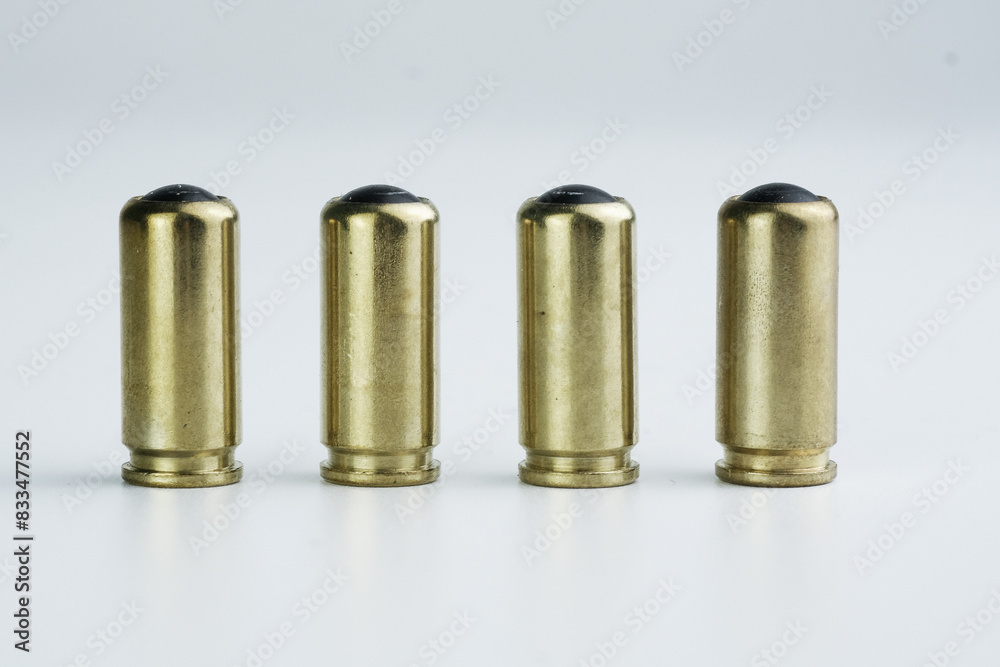 Brass bullet shells arranged in a group on a plain white background Brass bullet shells arranged in a group on a plain white background