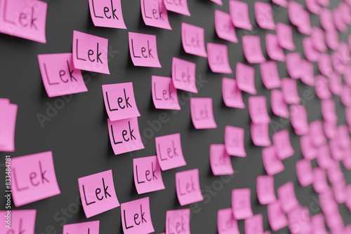 Many pink stickers on black board background with symbol of Albania lek drawn on them. Closeup view with narrow depth of field and selective focus. 3d render, illustration photo