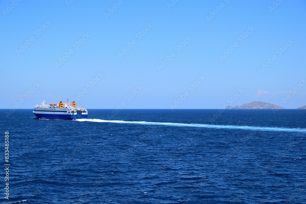Fototapeta premium blue ferryboat crossing the blue sea - near Lemnos island, Greece, aegean sea