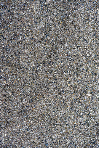 The river sand is coarse-grained. Small pebbles of river sand. Macrophotography of sand.