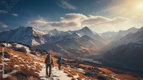 Two adventurers hike a snowy trail among majestic mountain peaks, signifying exploration and adventure