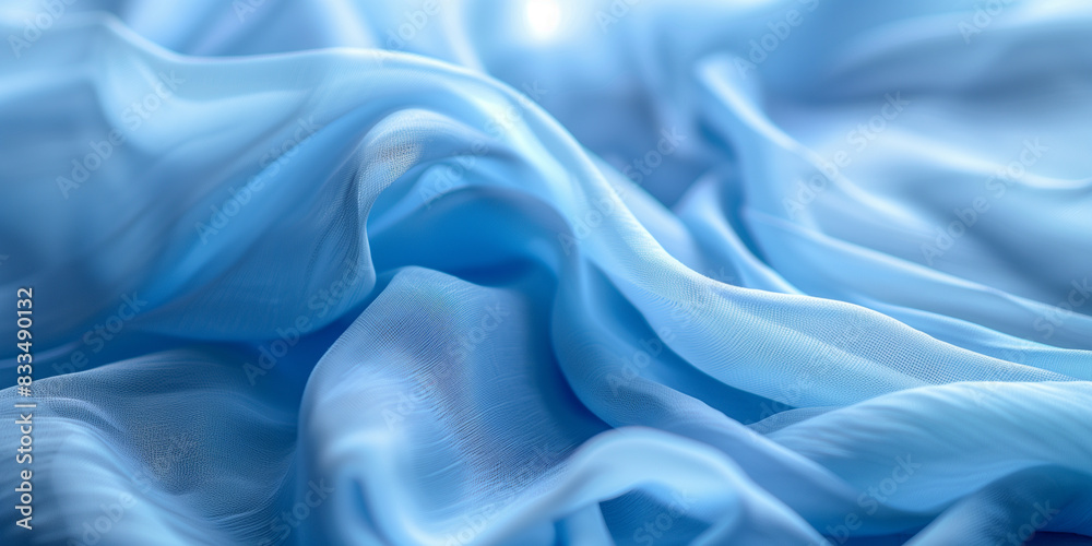 Obraz premium Blue fabric with delicate folds. Silk satin fabric backdrop with copy space.