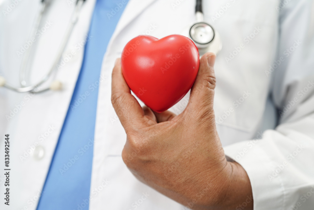 Doctor holding a red heart in hospital, heart Attack. Doctor holding a red heart in hospital, heart Attack.