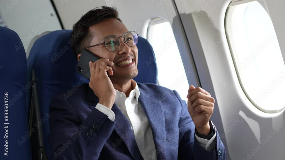 Traveling and technology. young businessman working on laptop computer and smartphone while sitting in airplane. Traveling and technology. young businessman working on laptop computer and smartphone while sitting in airplane.