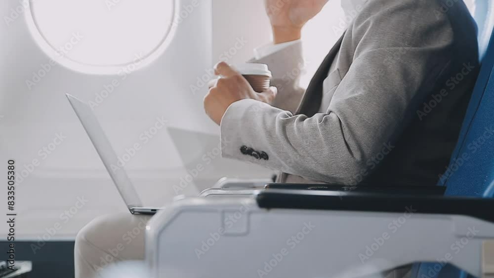 Side view portrait of handsome bearded businessman working while enjoying flight in first class, copy space