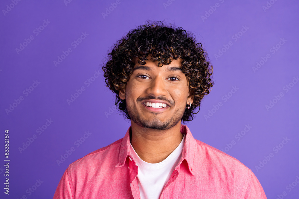 Photo of nice young man beaming smile wear pink shirt isolated on violet color background