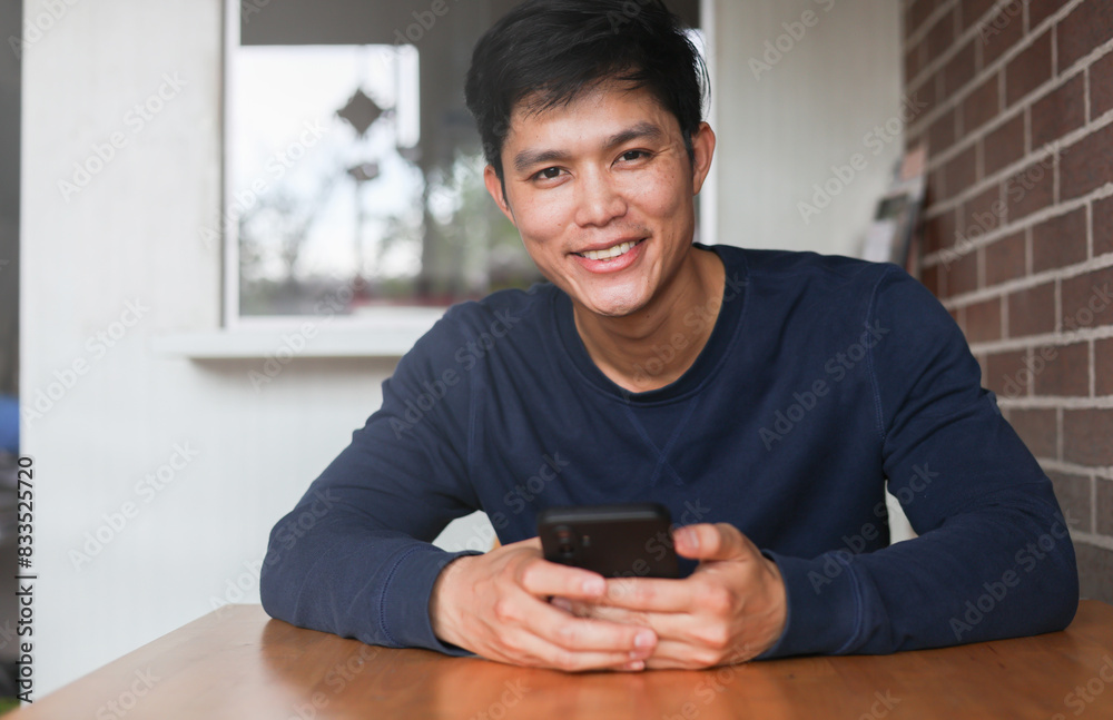 close up aisan young man hand use smartphone and check about social media news feed while smiling in the vacation for people lifestyle concept close up aisan young man hand use smartphone and check about social media news feed while smiling in the vacation for people lifestyle concept
