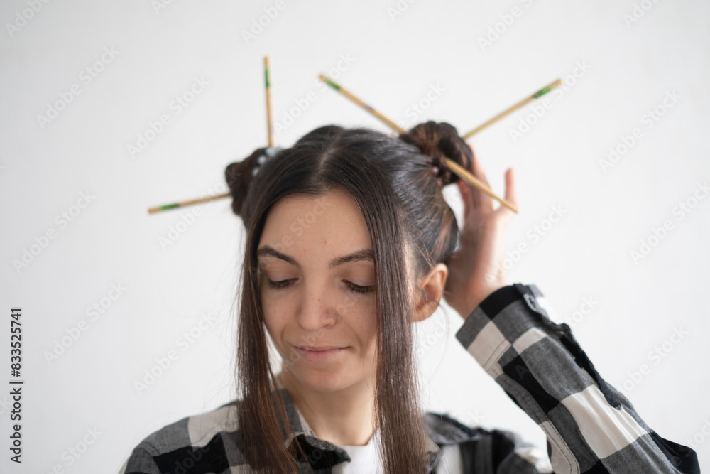 Stylish Young Girl With Artistic Hairstyle and chopsticks in asian style Posing for a Casual Portrait Stylish Young Girl With Artistic Hairstyle and chopsticks in asian style Posing for a Casual Portrait