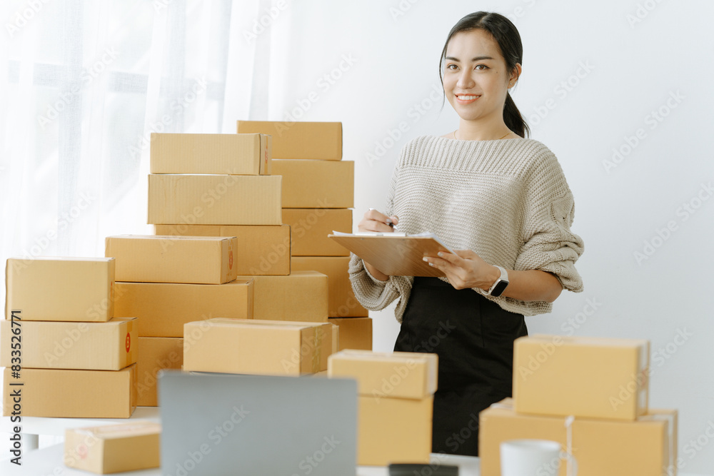 businesswoman start small business and successful SME entrepreneurs asian woman hoding boxs works from home delivering parcels online. SME delivery businesswoman start small business and successful SME entrepreneurs asian woman hoding boxs works from home delivering parcels online. SME delivery