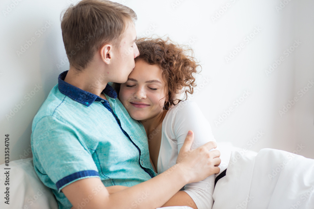 Love couple lying on white bed in morning happy and carring together Love couple lying on white bed in morning happy and carring together