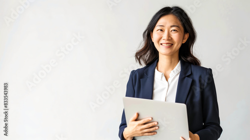 Chinese corporate woman posing with a laptop