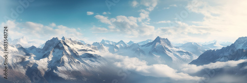 Top view of a mountain from an airplane. Breathtaking view through the clouds, illuminated by the soft light, natures grandeur. Inspiring view of snow-covered peak