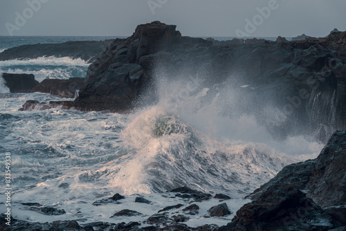 waves beating against the rocks in El Puertillo at sunset. Arucas. Gran Canaria. Canary islands photo