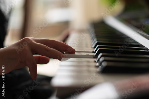 Little children's fingers play the piano. Soft focus photo