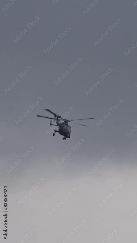 Advanced Military Helicopter Flying in the distance at air base Advanced Military Helicopter Flying in the distance at air base