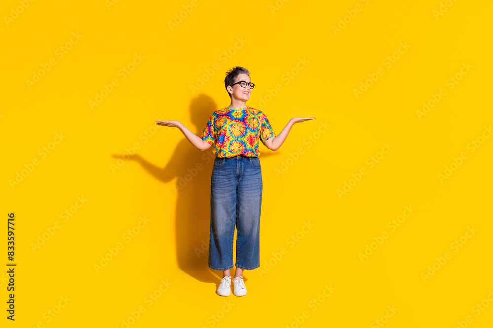 Photo of pretty nice senior woman wear stylish clothes hold look empty space isolated on yellow color background Photo of pretty nice senior woman wear stylish clothes hold look empty space isolated on yellow color background