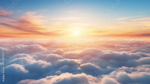 Stunning aerial view above the clouds during a mesmerizing sunset, sun rays piercing through the mist