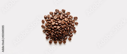 Coffee beans isolated on a white background. Freshly roasted and aromatic coffee beans. Top view.