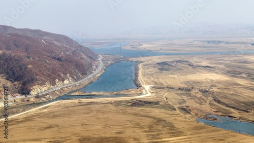 Tiger Mountain Great Wall, UNESCO World Heritage Site, near Dandong, Liaoning Province, China, panoramic elevated view of the Yalu River that separates China (left) from North Korea (right) photo