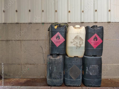 Jerry cans of flammable chemicals are stacked in piles