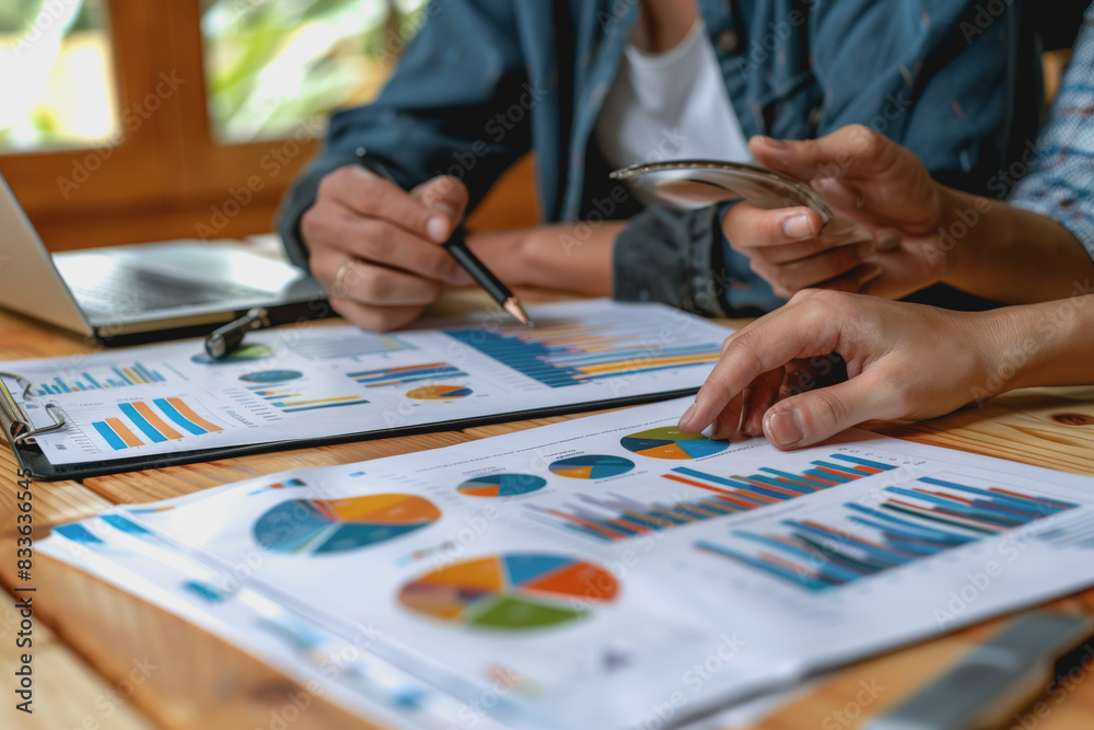Business team meeting to analyze data charts for marketing plans and office profits. Business team meeting to analyze data charts for marketing plans and office profits.