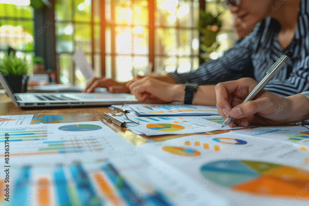 Business team meeting to analyze data charts for marketing plans and office profits. Business team meeting to analyze data charts for marketing plans and office profits.