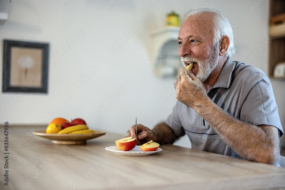 Portrait of a senior man eating an apple Portrait of a senior man eating an apple