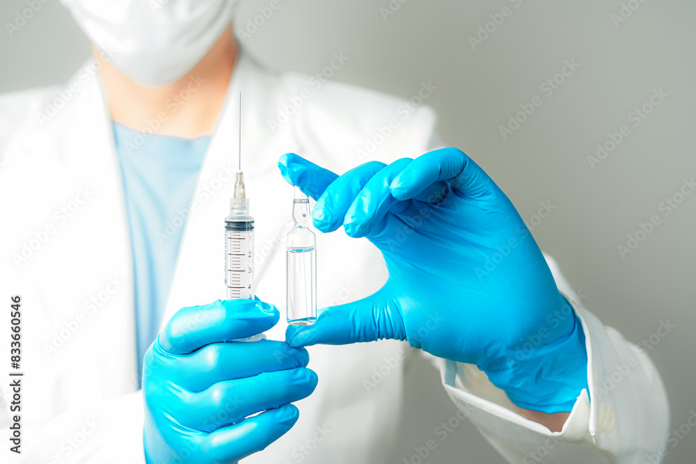 doctor or scientist holding ampules medicine vaccine and bottle for injection