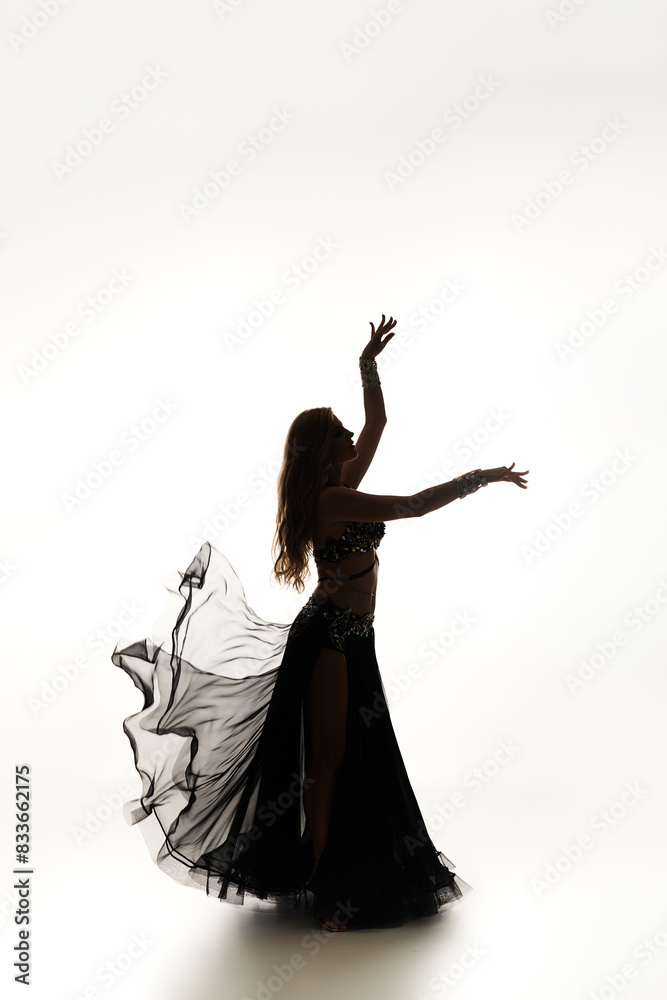 Young woman with elegance dances in black dress. Young woman with elegance dances in black dress.