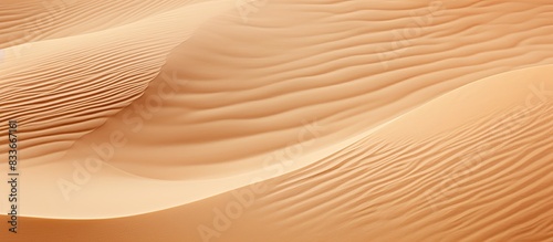 A detailed shot of sand with a gentle wave in the background providing ample copy space for adding images or text © StockKing