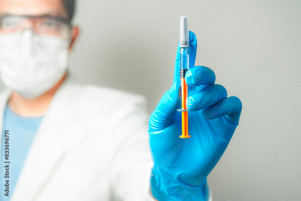 doctor or scientist holding a syringe in blue gloves doctor or scientist holding a syringe in blue gloves