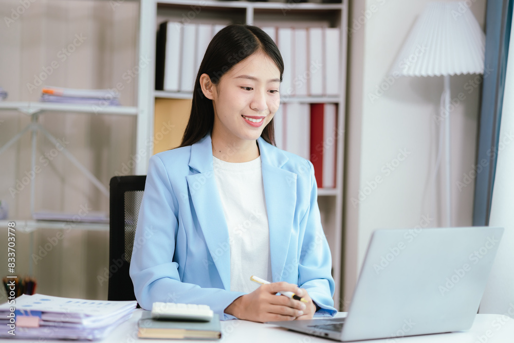 Happy young woman uses laptop computer for virtual meeting Have a video call at home Cheerful Asian woman communicating with colleagues and friends Happy young woman uses laptop computer for virtual meeting Have a video call at home Cheerful Asian woman communicating with colleagues and friends