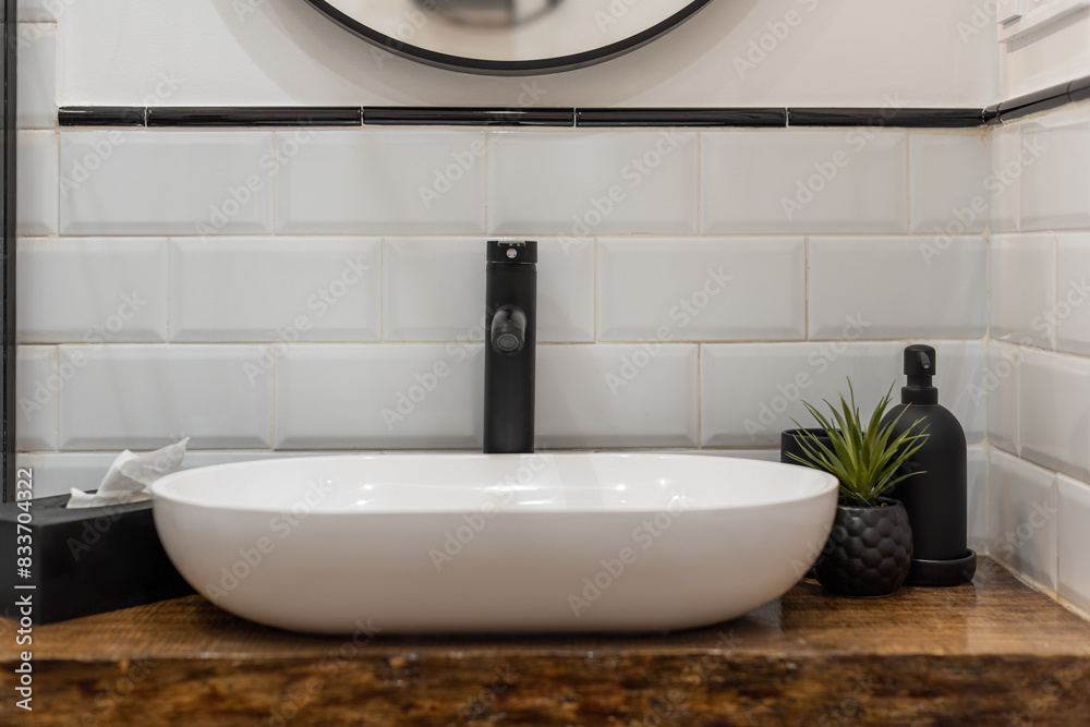Fototapeta premium Modern Bathroom Sink with Black Faucet and Decor