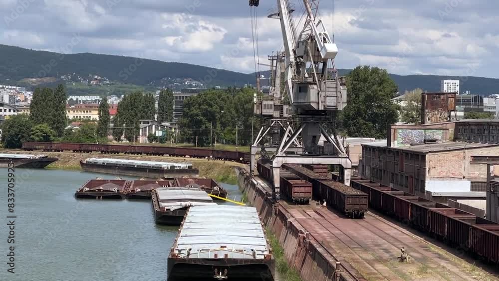 Cargo industrial river port, port crane. Loading of coal on barge Cargo industrial river port, port crane. Loading of coal on barge