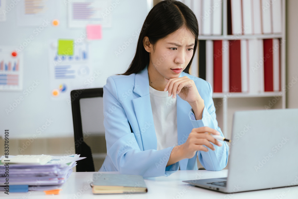 Asian businesswoman who is suffering from headache and stress due to overwork. Asian businesswoman who is suffering from headache and stress due to overwork.