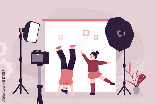 Cute girl and boy at photo session, photographer making photos. Active caucasian kids before camera. Photo studio interior with equipment