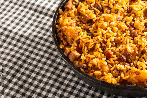 Baião de Dois traditional Brazilian food with rice, beans, sausage and rennet cheese close up photo