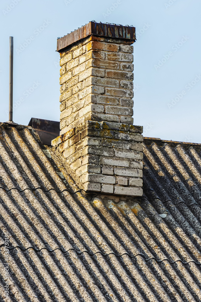 Old brick messy cracked chimney of a house Old brick messy cracked chimney of a house