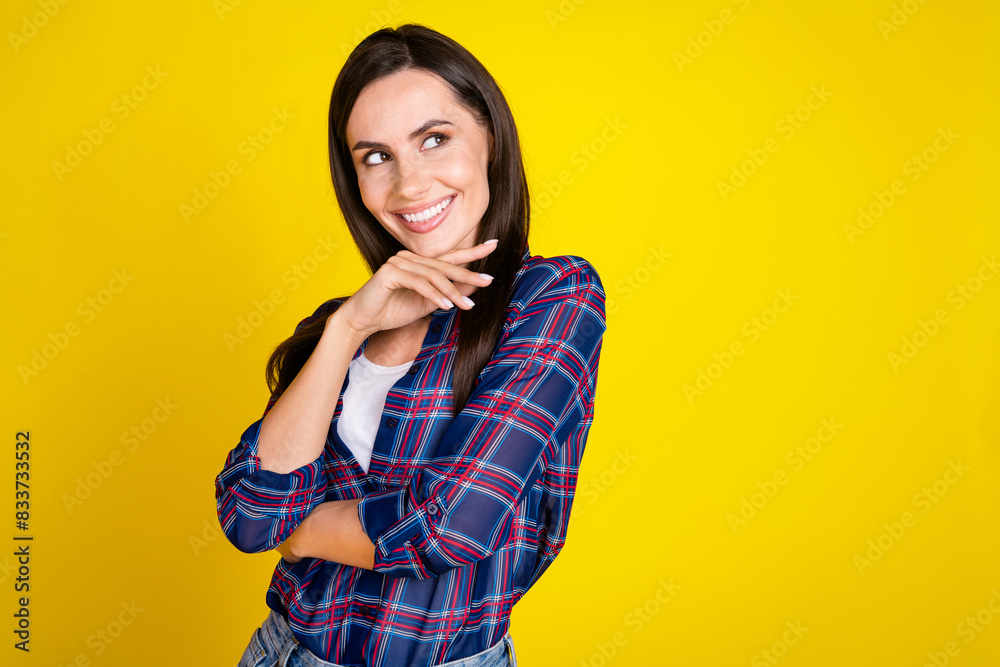Photo portrait of lovely young lady look empty space interested dressed stylish plaid garment isolated on yellow color background