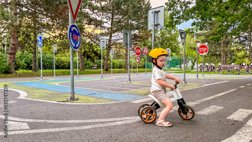 A child learns the rules of the road on his bike - a training park for children