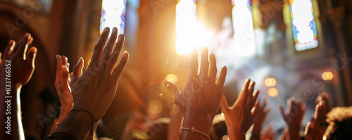 People raising hands towards light in a church.