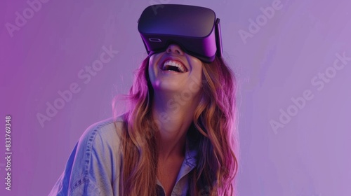 portrait of young woman smiling wearing VR Headset on purple background © Sunshine mood