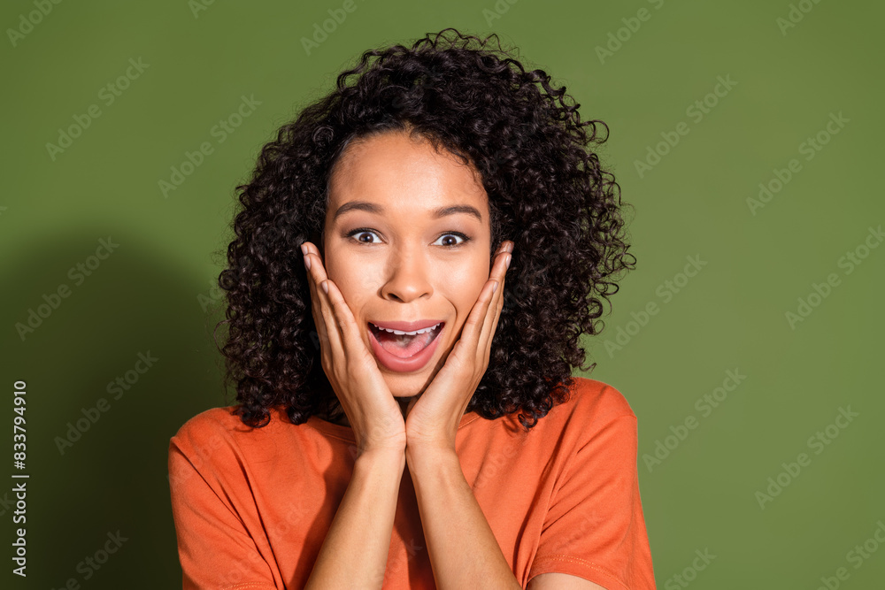 Photo portrait of lovely young lady amazed touch cheeks dressed stylish orange garment isolated on khaki color background Photo portrait of lovely young lady amazed touch cheeks dressed stylish orange garment isolated on khaki color background