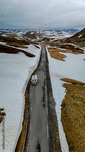 Campervan or motorhome travel camper van, Caravan trailer, or camper RV at the Lyse road covered with snow to Krejag Norway Lysebotn, a road covered with snow in the mountains photo