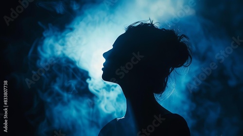 mysterious woman silhouette in dark aesthetic backdrop with dramatic shadows and highlights © Bijac