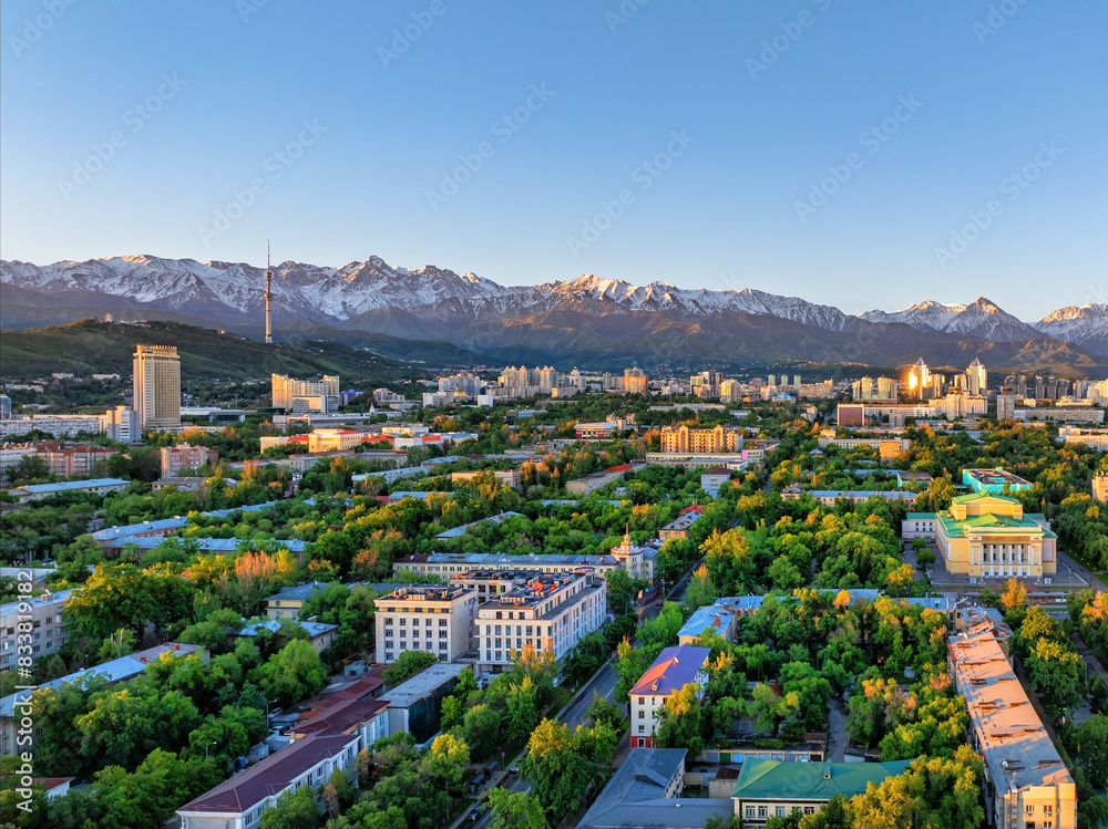 View from a quadcopter of the central part of the Kazakh city of Almaty on a spring morning against the backdrop of a mountain range