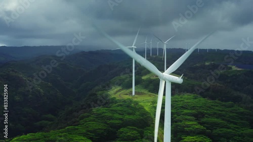 Aerial View of Green Valley with Wind Turbines and Cloudy Sky, Showcasing Renewable Energy Harmony