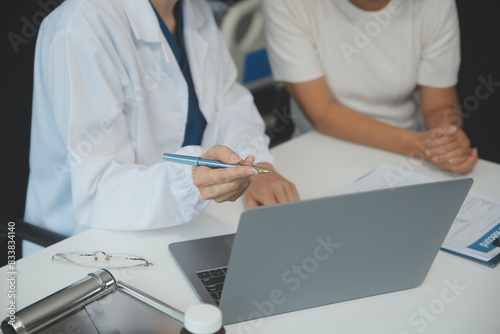 Doctor using sphygmomanometer with stethoscope checking blood pressure to a patient in the hospital.