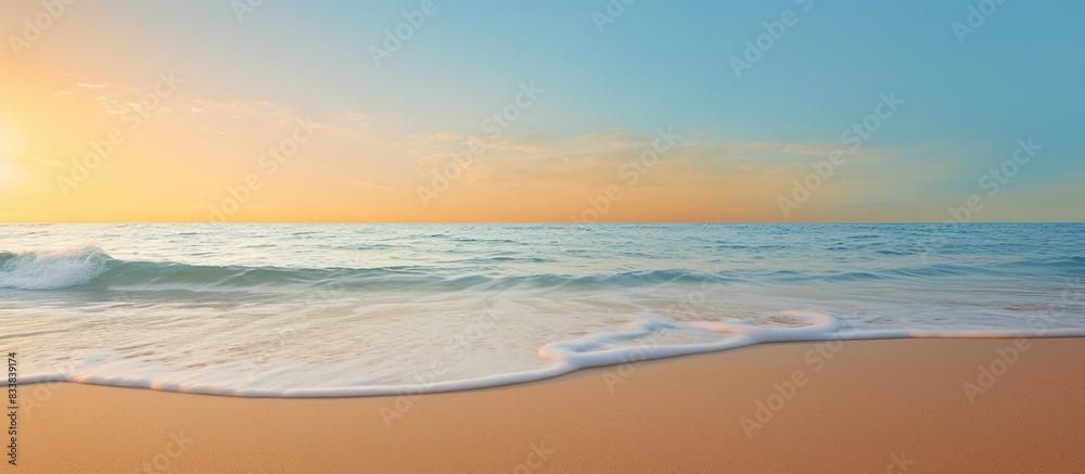 Golden sand beach with clear blue ocean and a sunset in the background, ideal for a summer or spring abstract background with copy space image. Golden sand beach with clear blue ocean and a sunset in the background, ideal for a summer or spring abstract background with copy space image.
