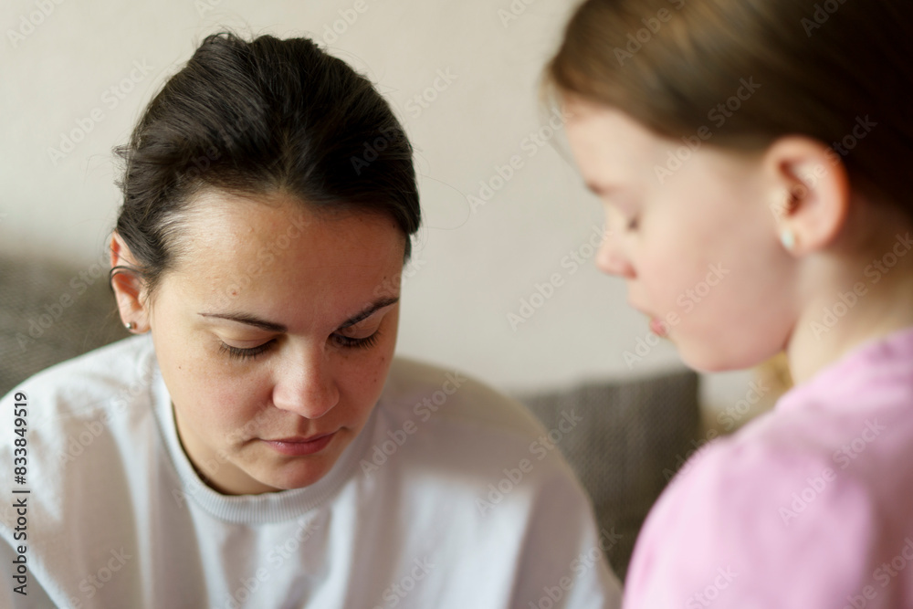 Sad mother and her daughter in the living room Sad mother and her daughter in the living room